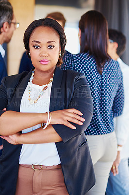 Buy stock photo Cropped portrait of a businesswoman standing in the office with her colleagues in the background