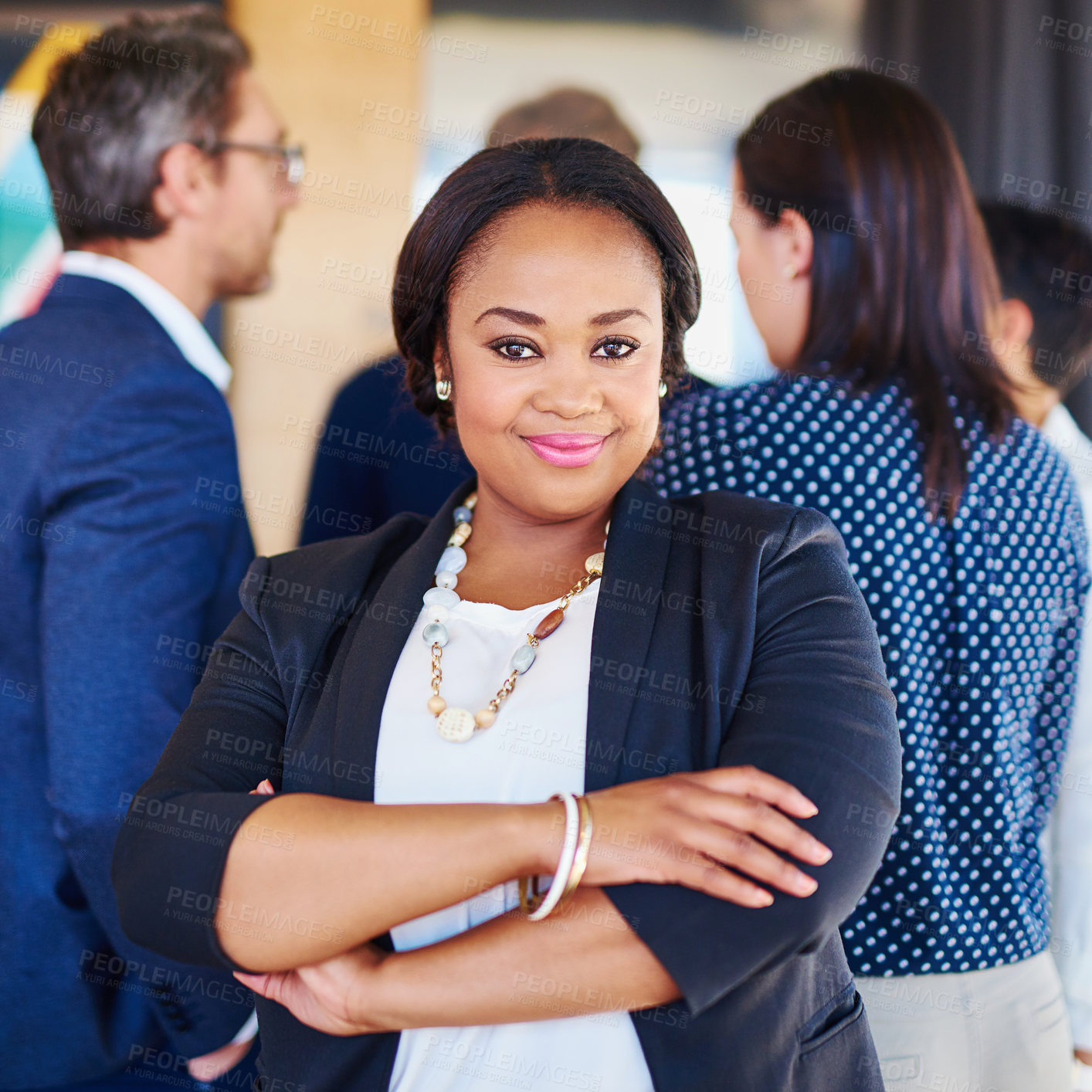 Buy stock photo Cropped portrait of a businesswoman standing in the office with her colleagues in the background