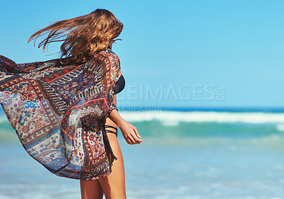 Buy stock photo Shot of a woman looking at the view of the beach