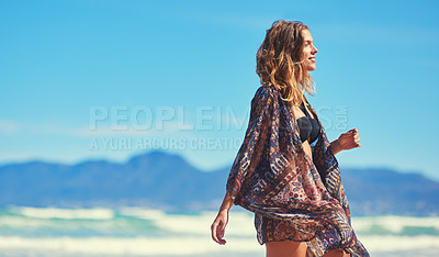 Buy stock photo Shot of a young woman enjoying a summer's day at the beach