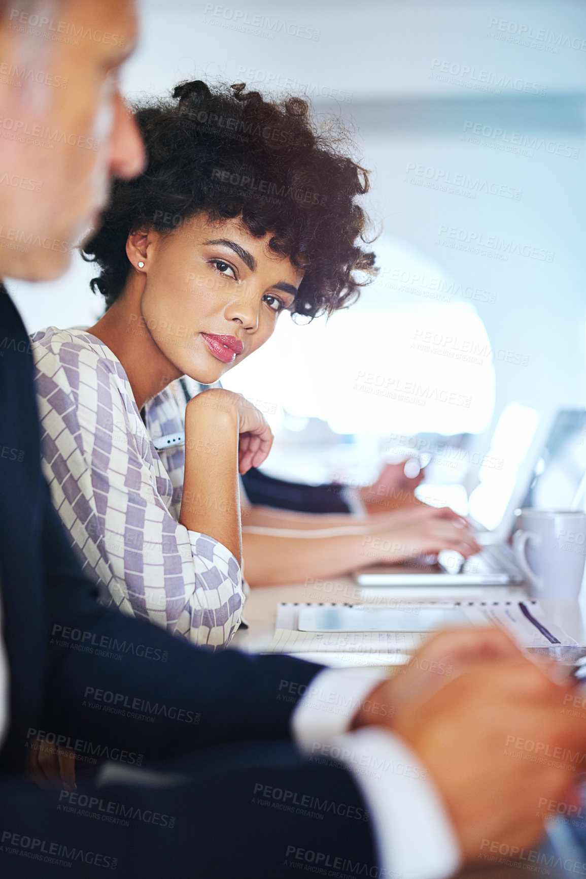 Buy stock photo Portrait of a young businesswoman working at her desk in an office