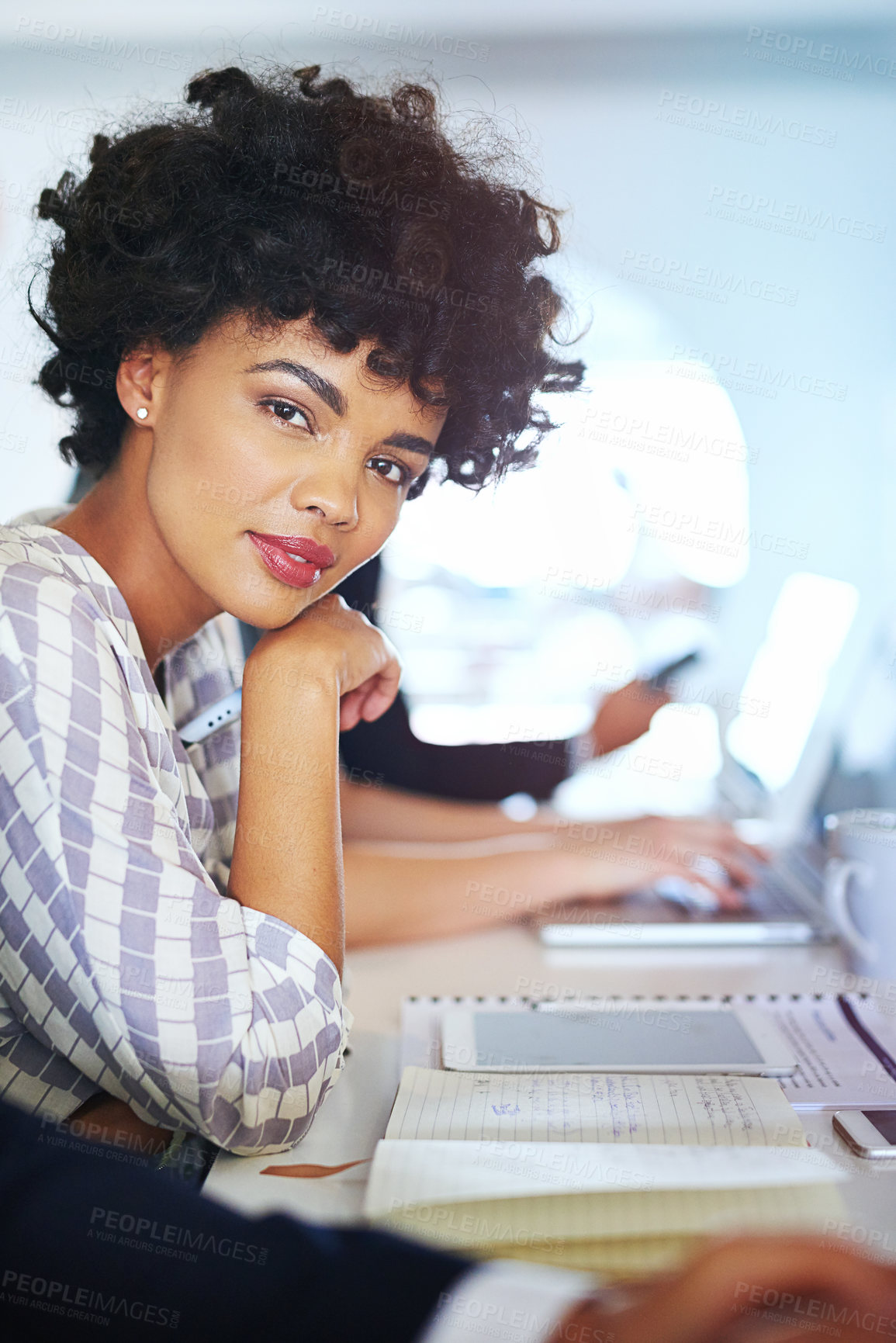 Buy stock photo Portrait of a young businesswoman working at her desk in an office