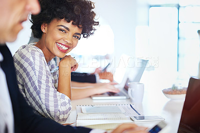 Buy stock photo Portrait of a young businesswoman working at her desk in an office
