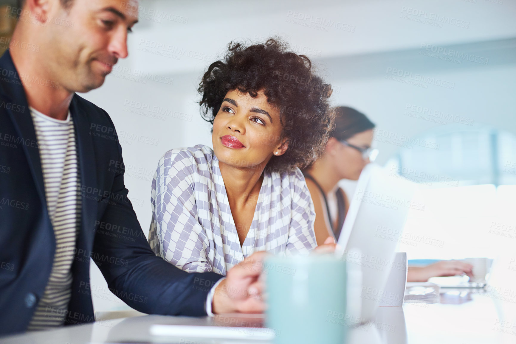 Buy stock photo Shot of coworkers using a laptop together in an office