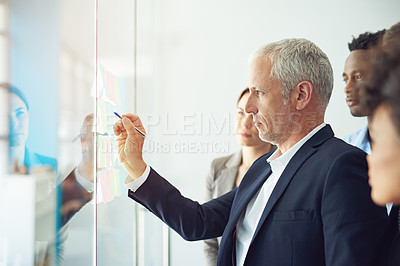 Buy stock photo Shot of a group of colleagues having a brainstorming session at work