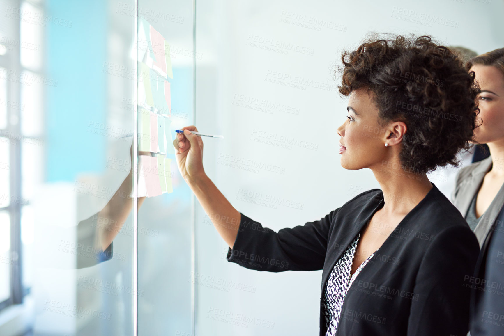 Buy stock photo Shot of colleagues having a brainstorming session at work