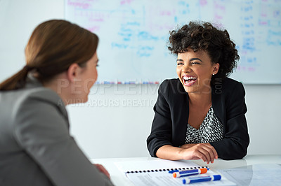 Buy stock photo Shot of two businesswomen enjoying a meeting together at work