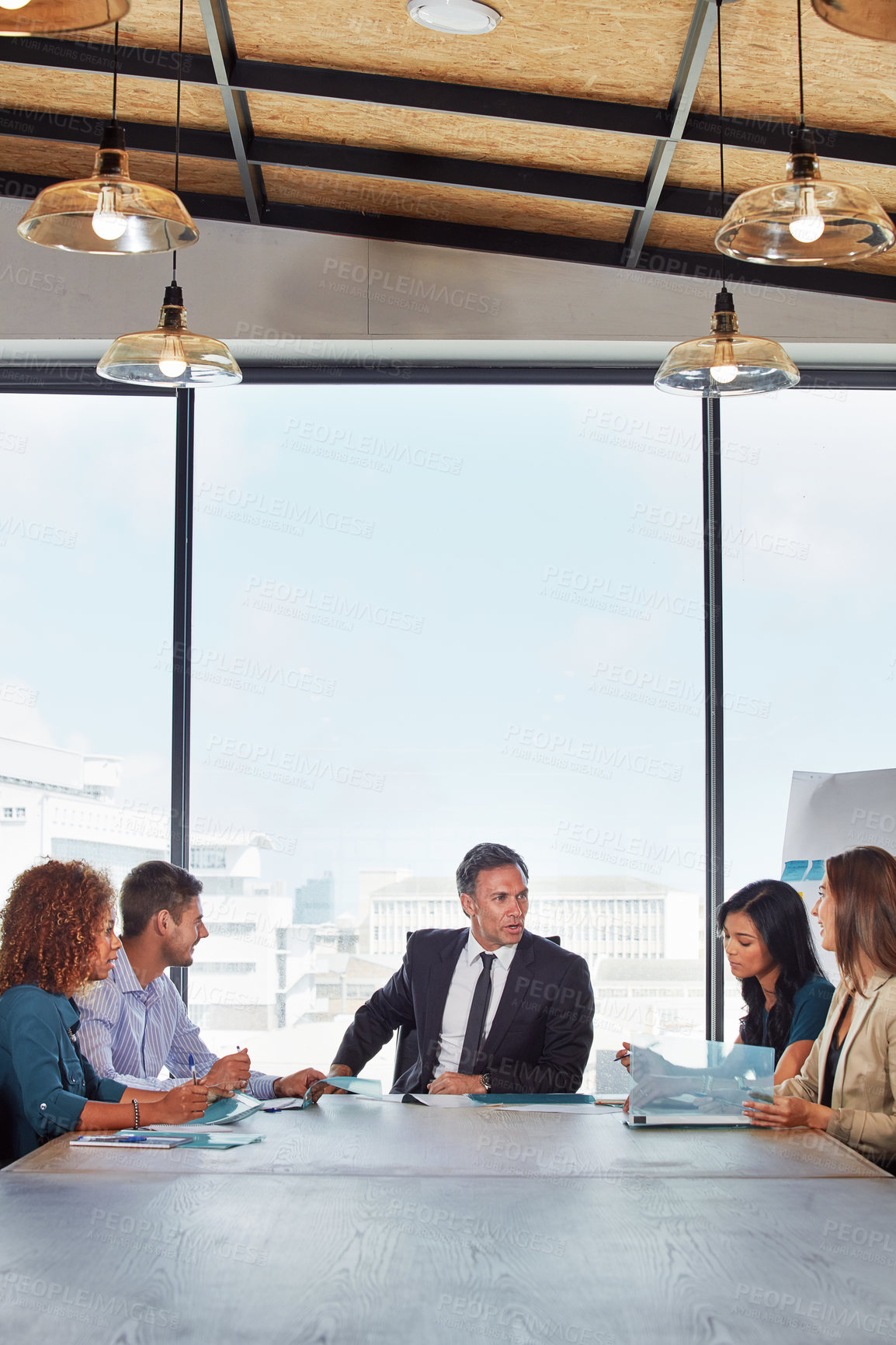 Buy stock photo Shot of a group of businesspeople in a meeting