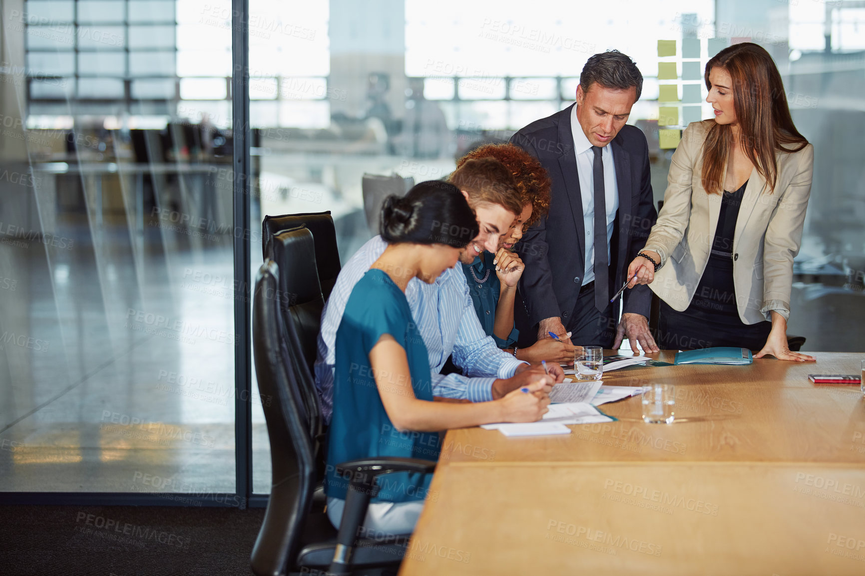 Buy stock photo Shot of a group of businesspeople having a meeting in the boardroom