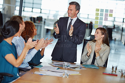 Buy stock photo Shot of a group of businesspeople clapping hands