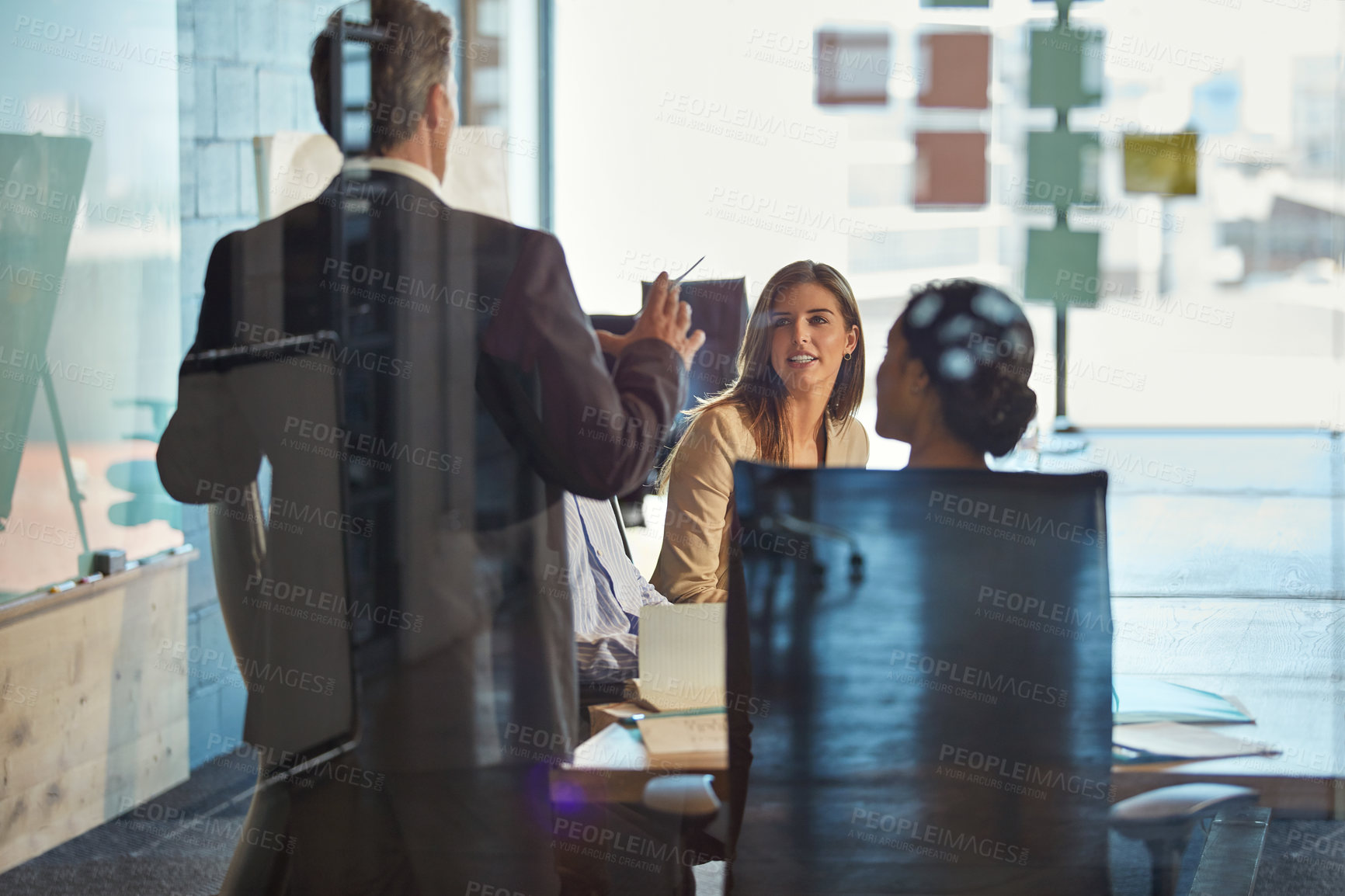 Buy stock photo Shot of a team of colleagues having a meeting in an office