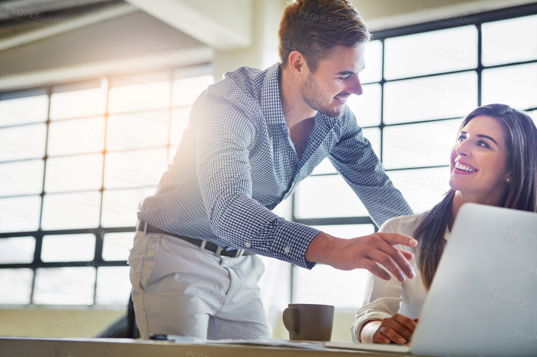 Buy stock photo Shot of two colleagues using a computer in an office