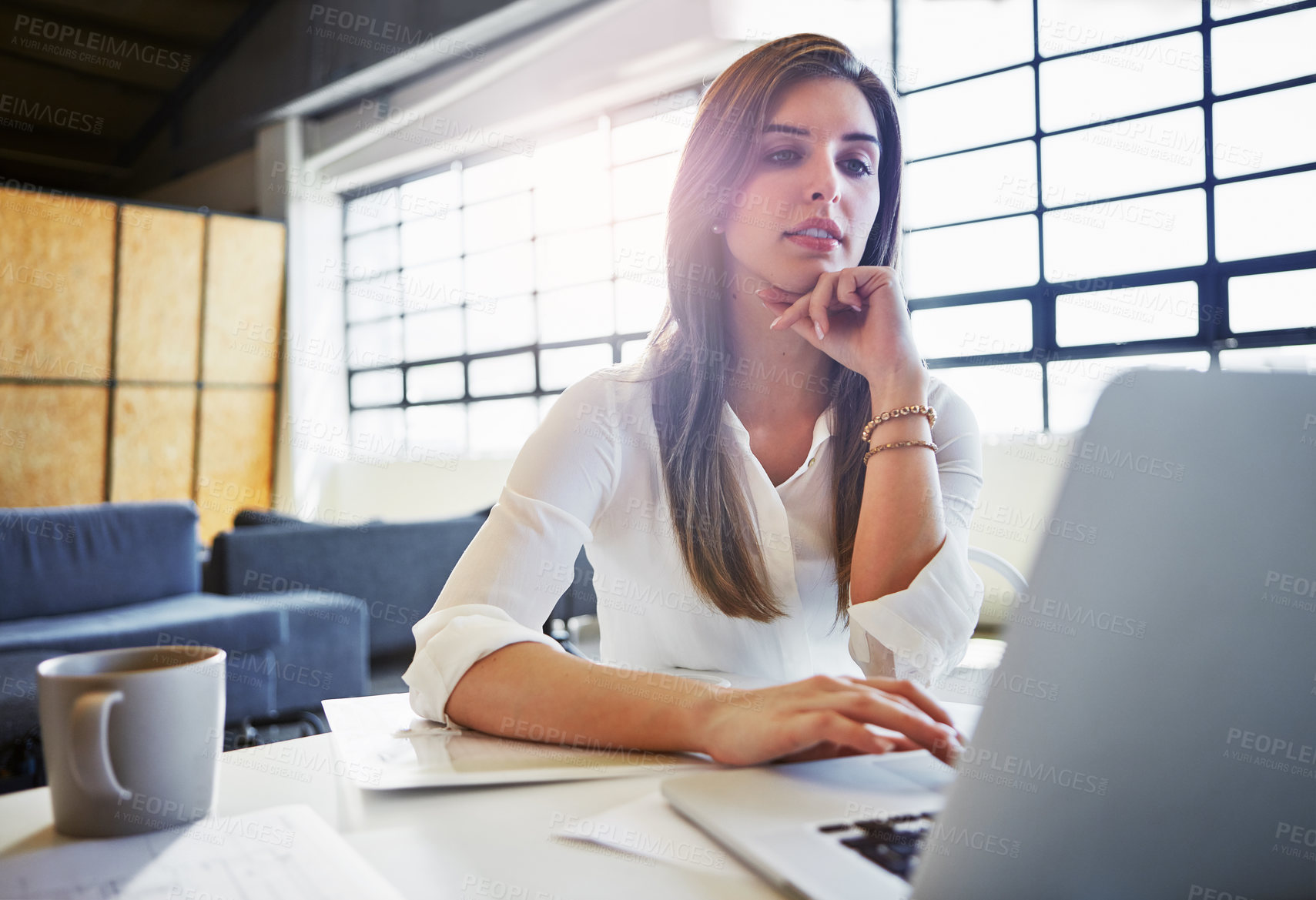 Buy stock photo Shot of a businesswoman using a laptop in an office