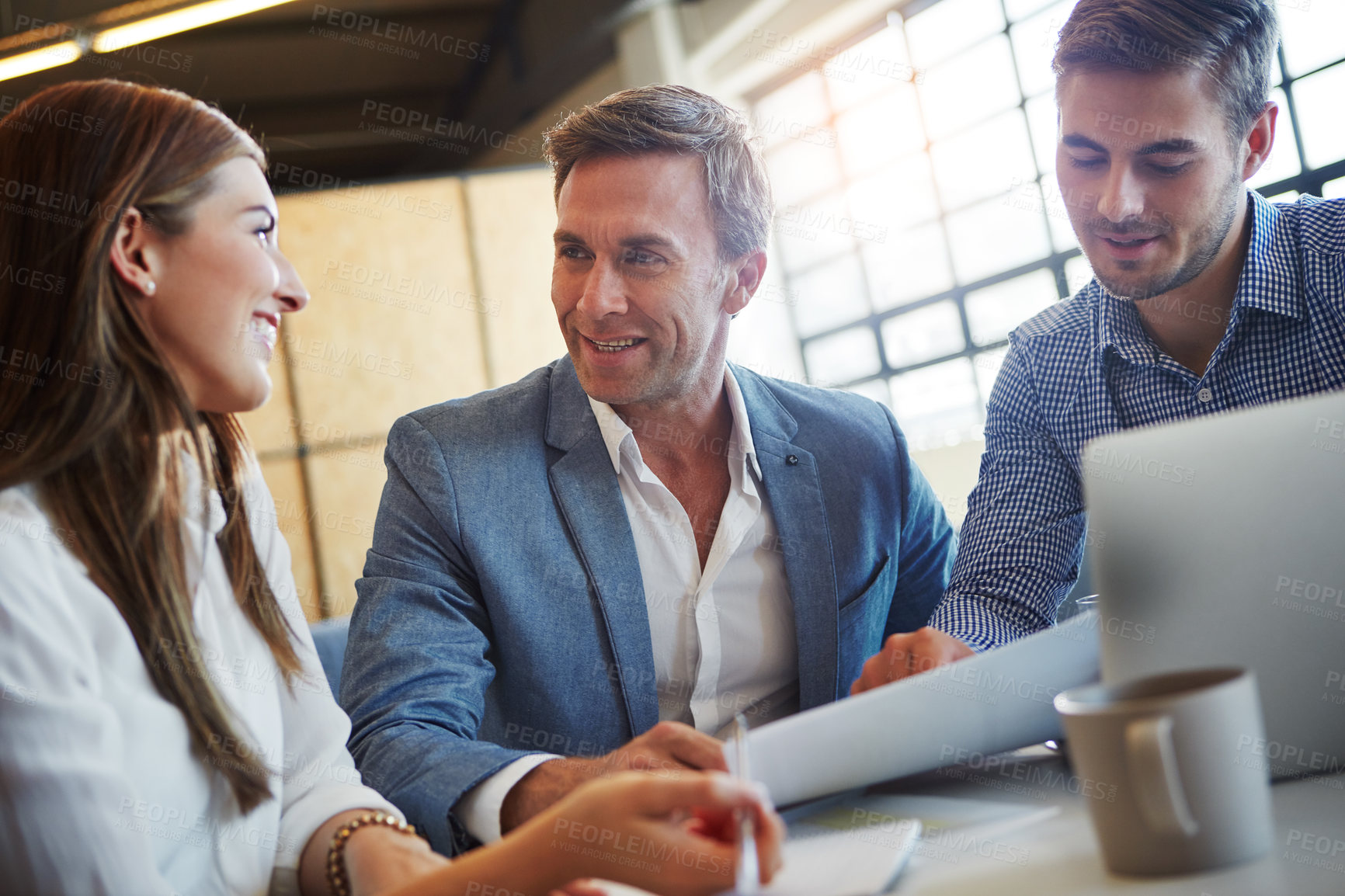 Buy stock photo Cropped shot of three businesspeople working in the office