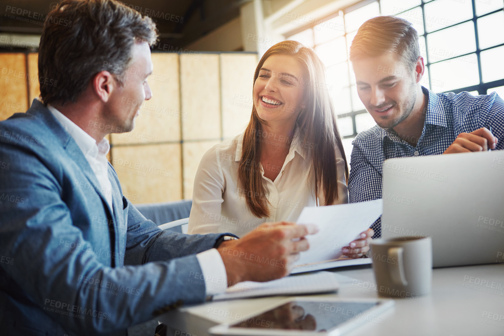 Buy stock photo Cropped shot of three businesspeople working in the office