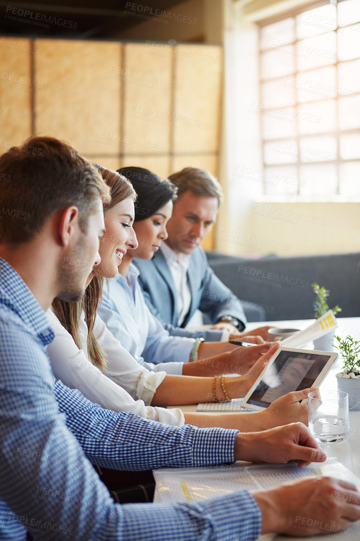 Buy stock photo Cropped shot of a group of businesspeople working in the office