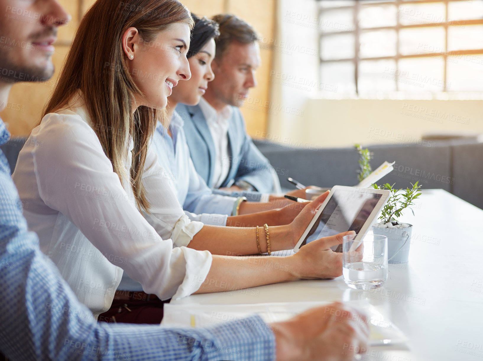 Buy stock photo Cropped shot of a group of businesspeople working in the office