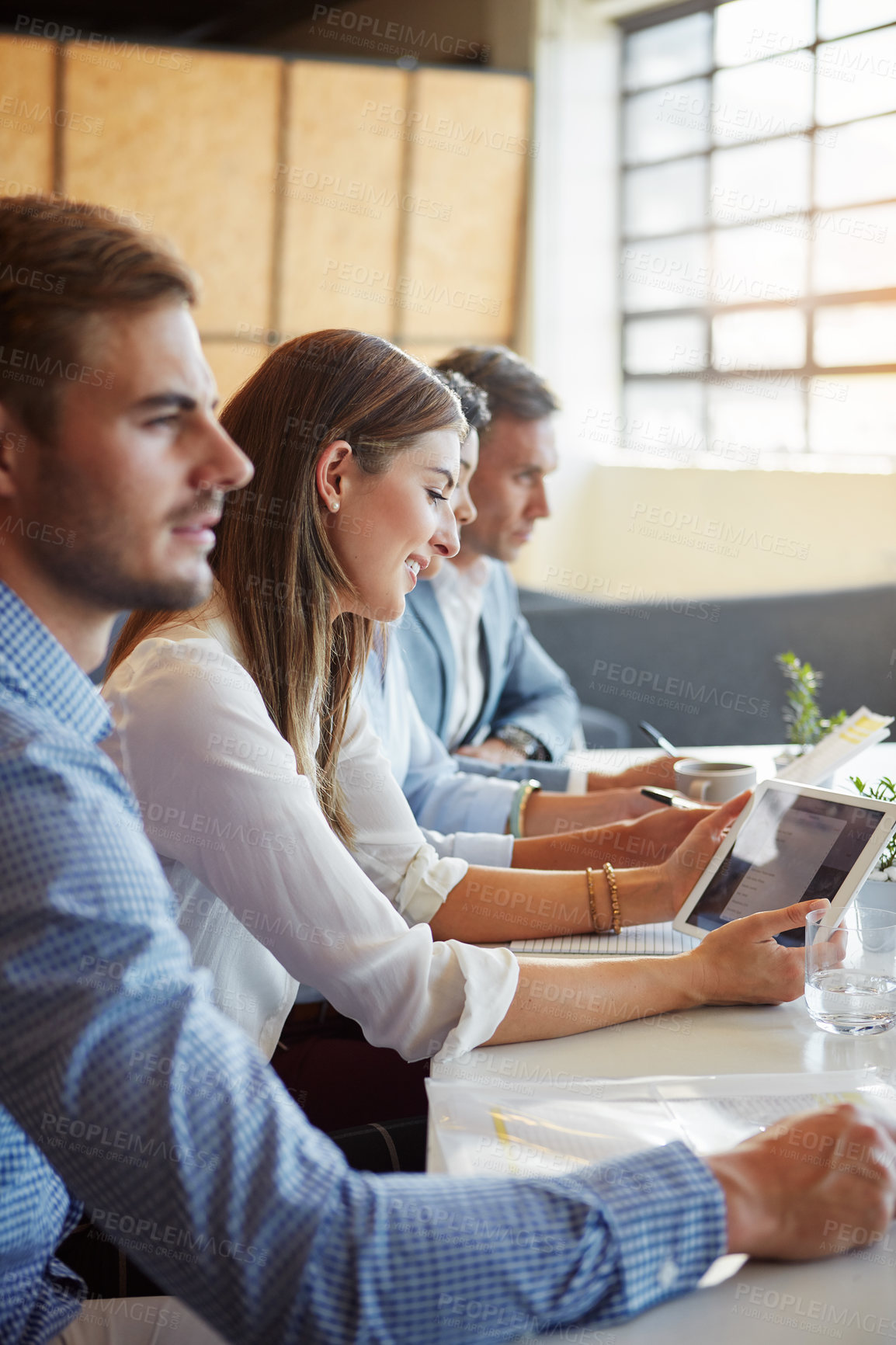 Buy stock photo Cropped shot of a group of businesspeople working in the office