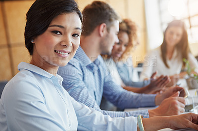 Buy stock photo Cropped portrait of a young businesswoman working in the office with her colleagues