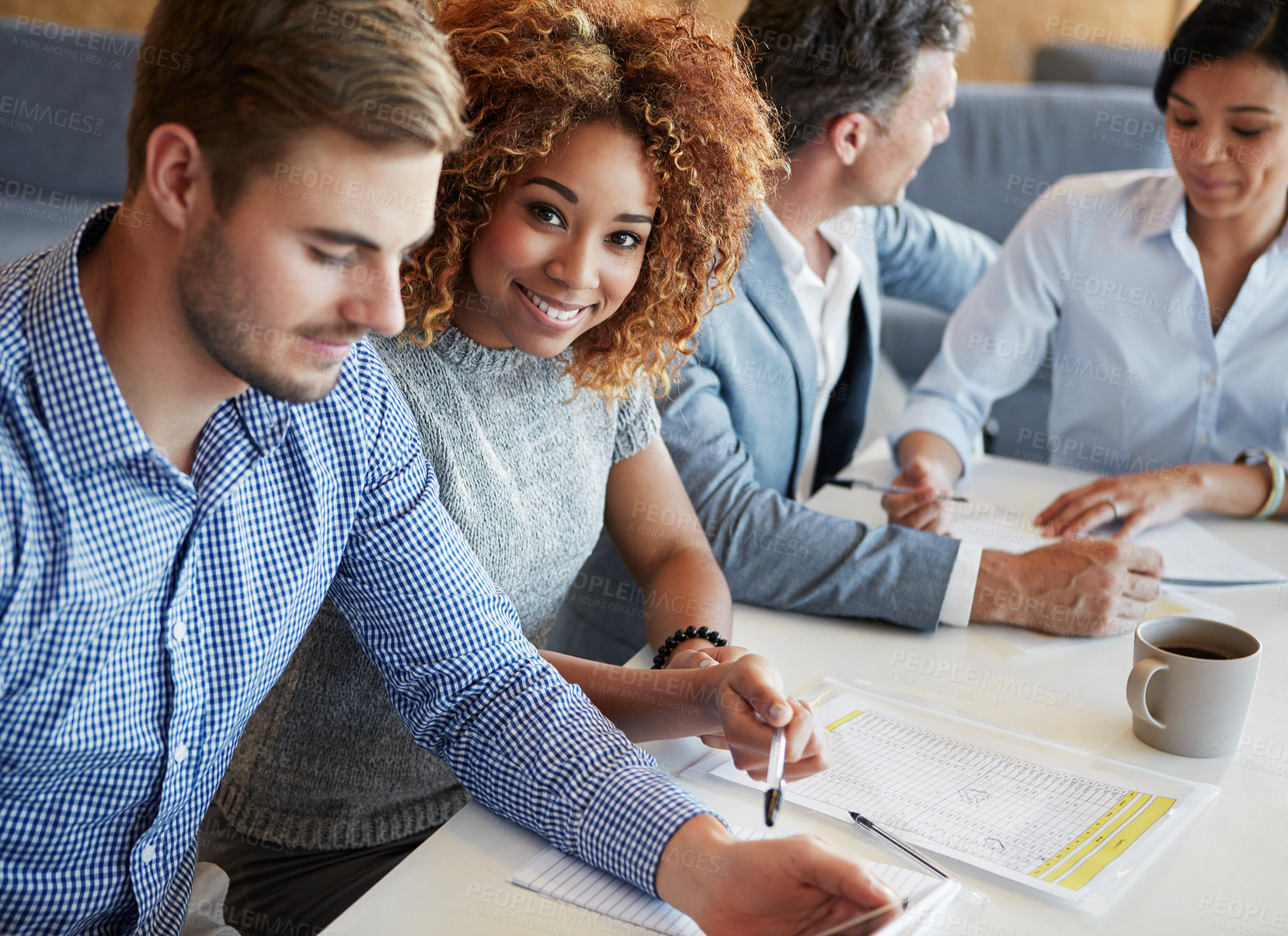 Buy stock photo Cropped portrait of a young businesswoman working in the office with her colleagues