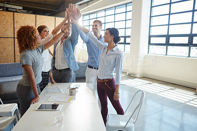 Buy stock photo Cropped shot of a group of businesspeople high fiving in the office