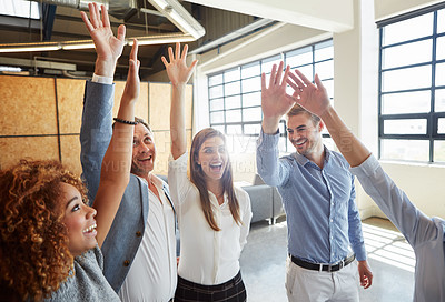 Buy stock photo Cropped shot of a group of businesspeople standing with their arms raised in the office
