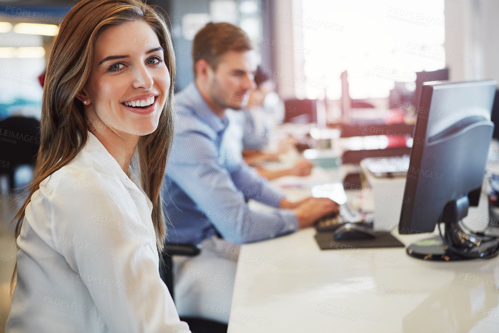 Buy stock photo Cropped portrait of a young businesswoman working in the office with her colleagues