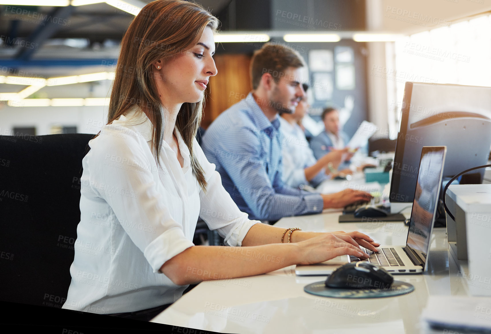 Buy stock photo Cropped shot of a group of businesspeople working in the office