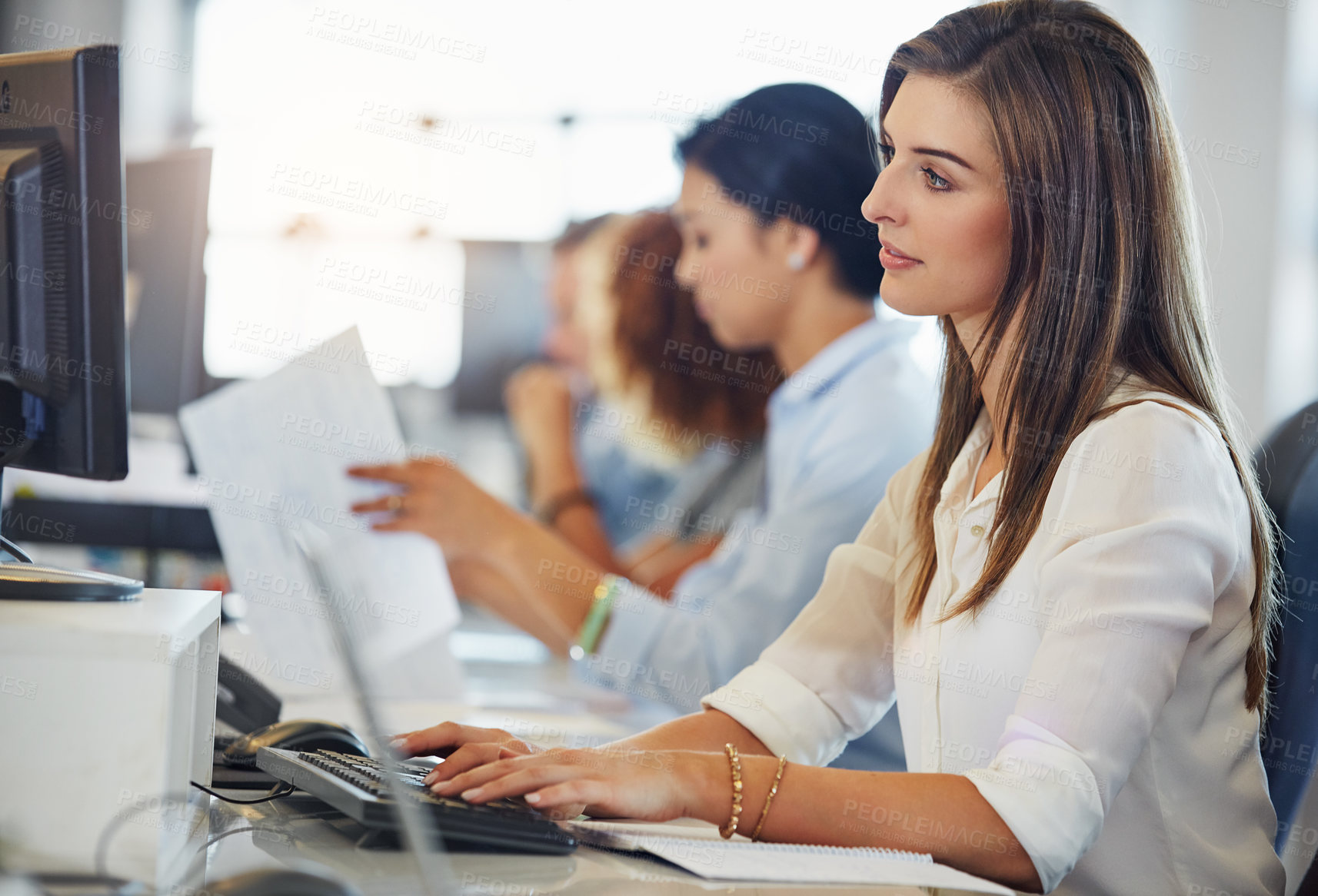 Buy stock photo Cropped shot of a group of businesspeople working in the office