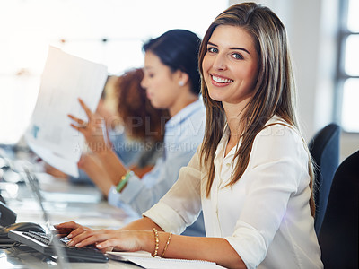Buy stock photo Cropped portrait of a young businesswoman working in the office with her colleagues