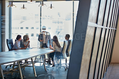 Buy stock photo Full length shot of a group of businesspeople meeting in the boardroom