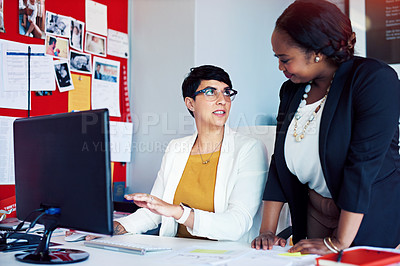 Buy stock photo Cropped shot of two businesswomen working in the office