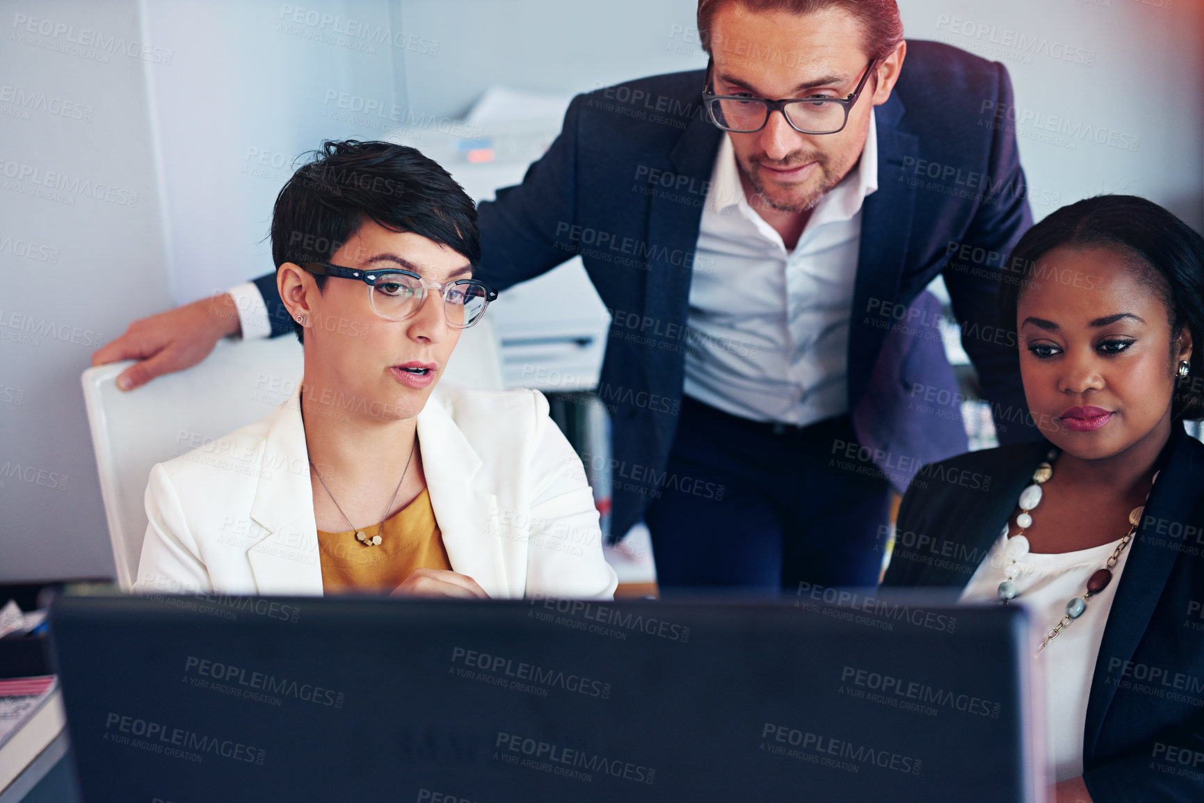 Buy stock photo Cropped shot of three business colleagues working in the office