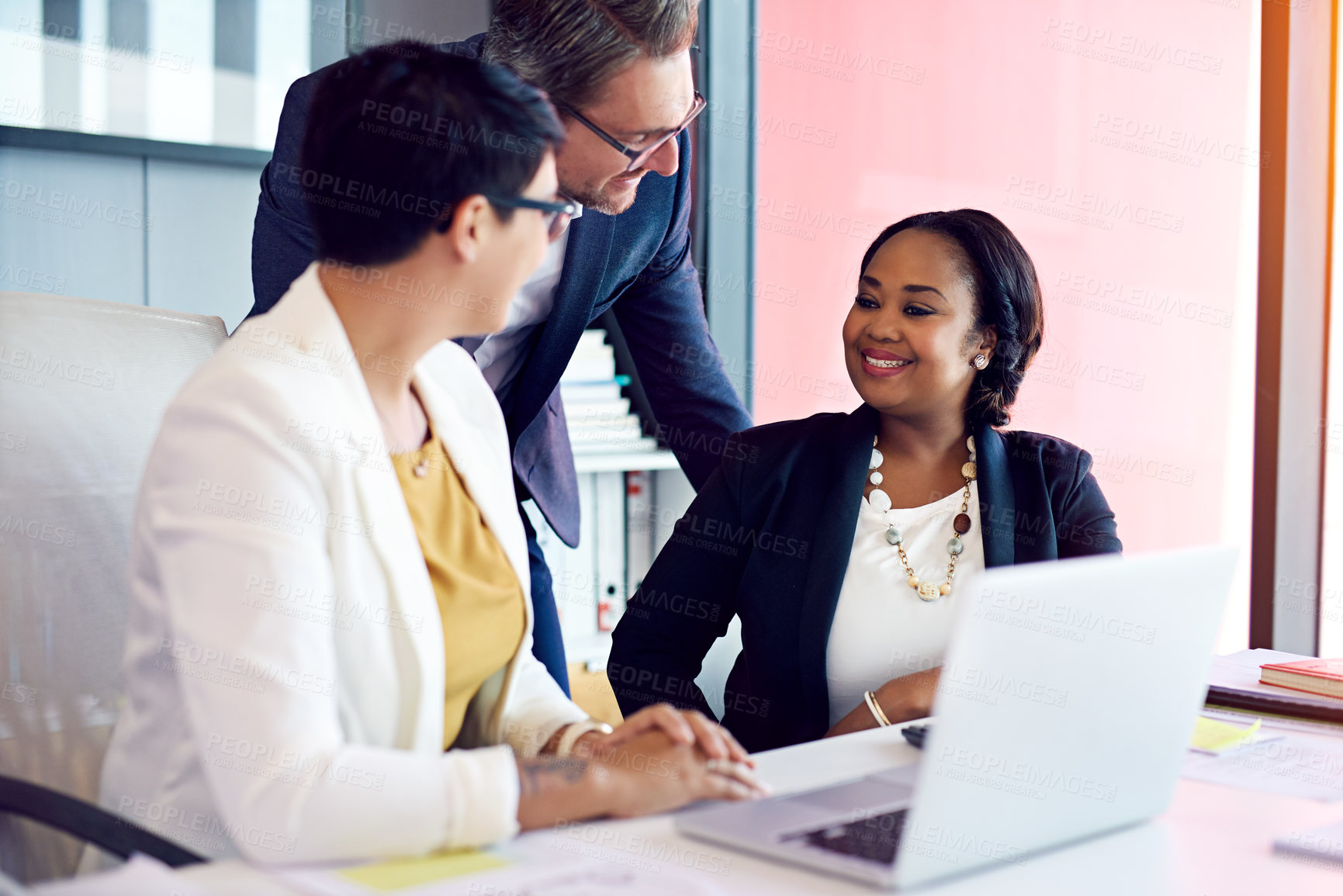 Buy stock photo Cropped shot of three business colleagues working in the office