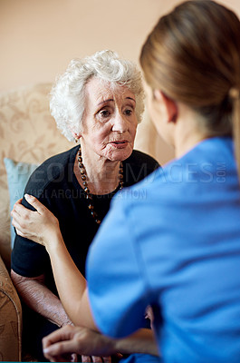Buy stock photo Shot of a nurse caring for an elderly woman at a nursing home