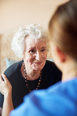 Buy stock photo Shot of a nurse caring for an elderly woman at a nursing home