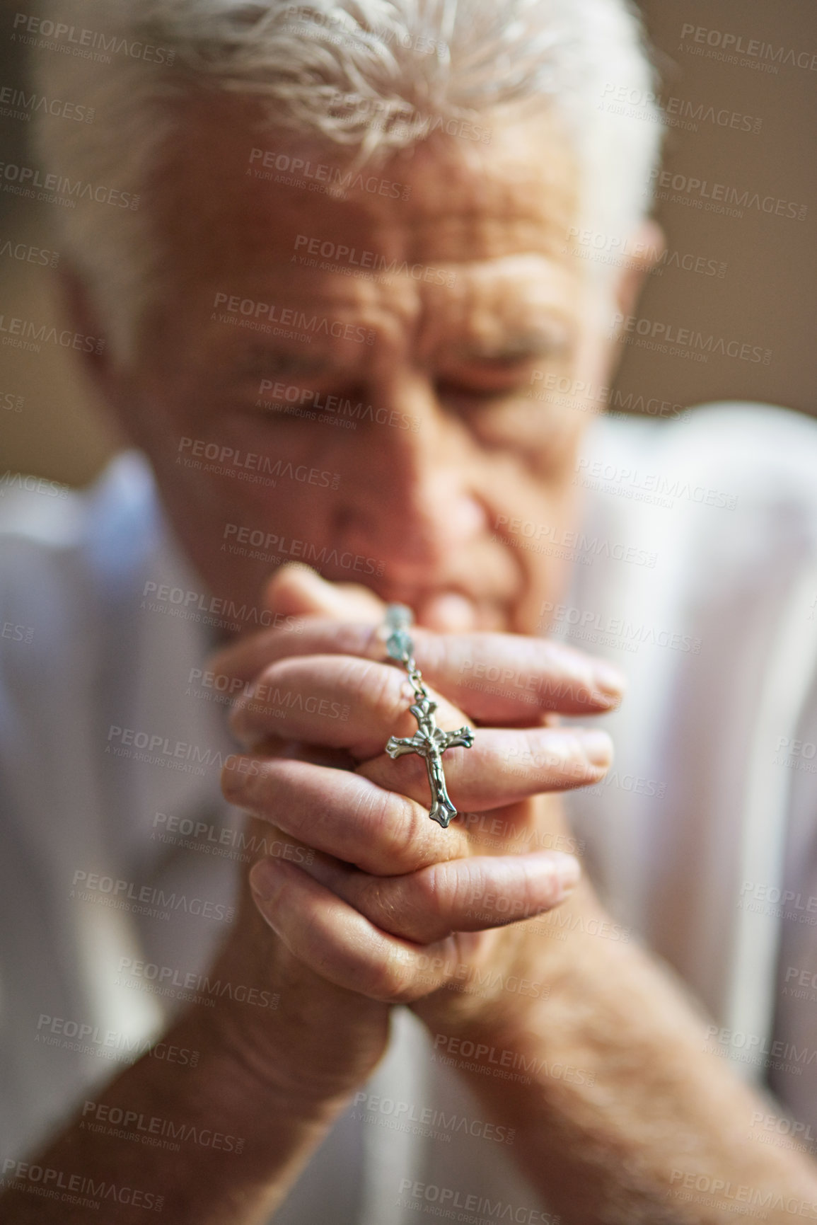 Buy stock photo Crucifix, rosary and senior man with prayer at home for religious healing, peace and worship to God. Retirement, Christian and elderly person with praying for faith, blessing and gratitude to Jesus