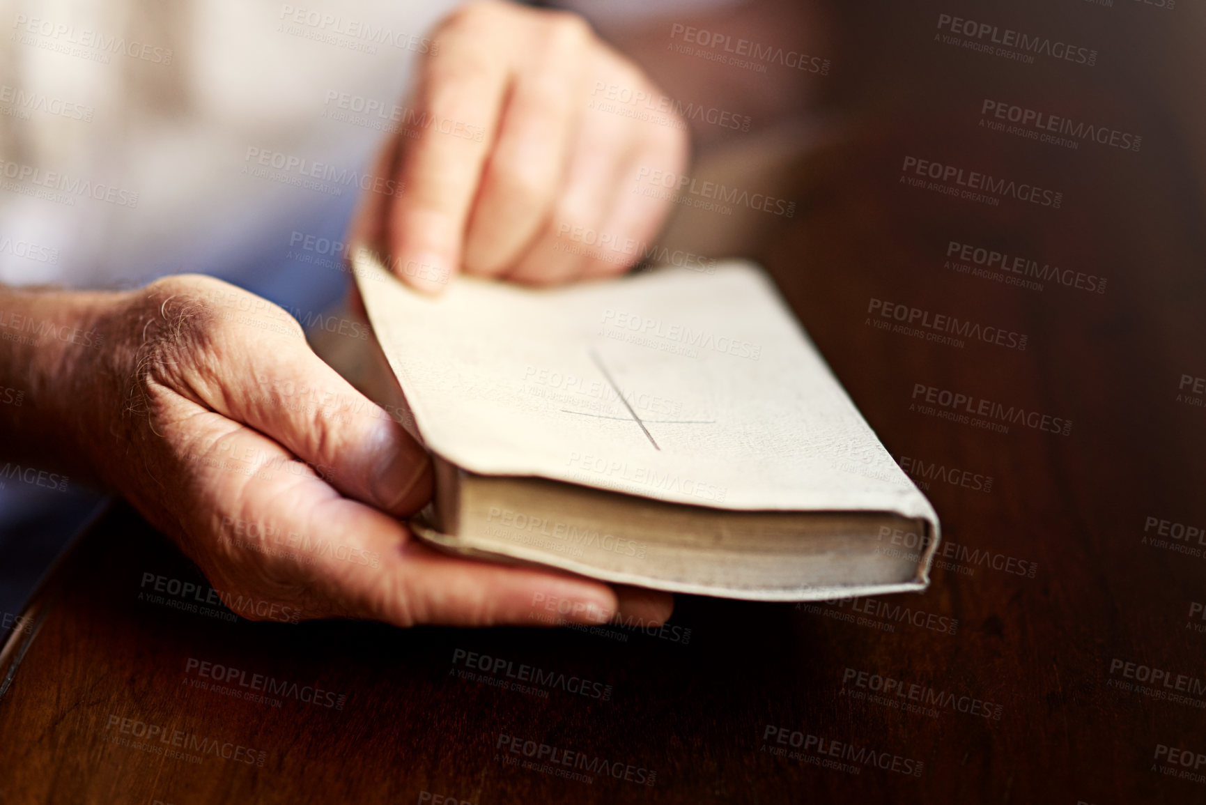 Buy stock photo Cropped shot of a man opening a bible