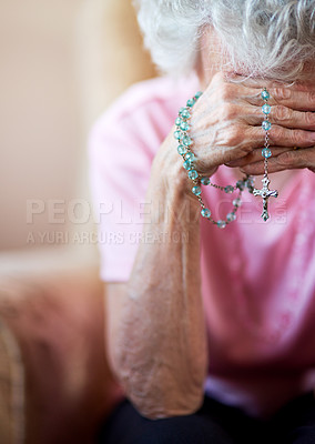 Buy stock photo Cropped shot an elderly woman holding a rosary in prayer