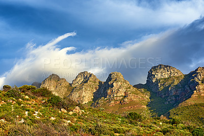 Buy stock photo Landscape view of mountains and blue sky in Cape Town, South Africa during summer holiday and vacation. Scenic hills of fresh green flora growing in remote area. Exploring mother nature and the wild