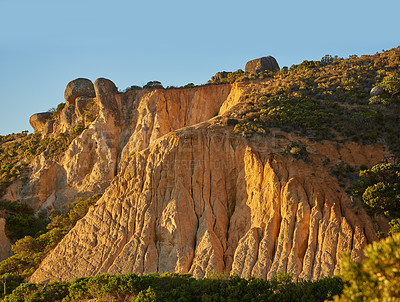 Buy stock photo Low angle view of a mountain peak in South Africa. Scenic landscape of a remote hiking location on Lions Head in Cape Town at sunset on a sunny day. Travelling and exploring nature through adventure