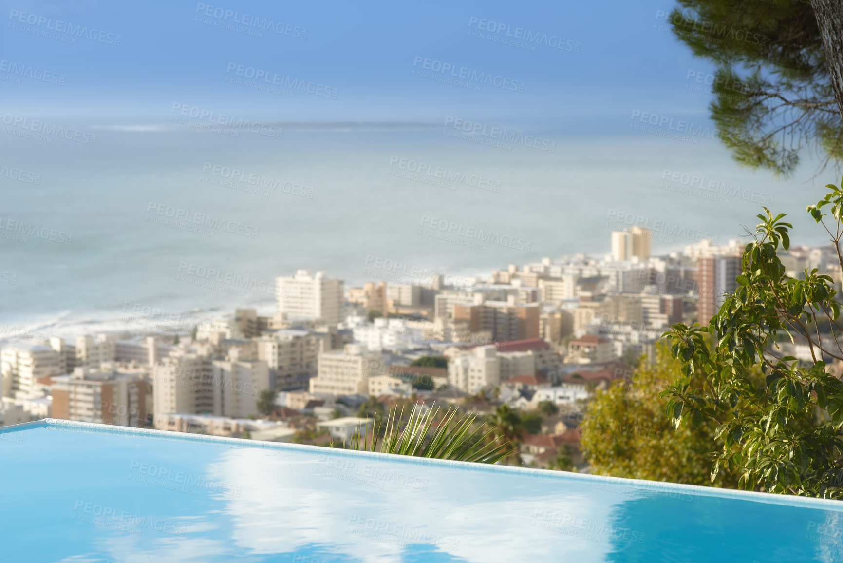 Buy stock photo Scenic view of infinity swimming pool overlooking Sea Point in Cape Town, South Africa with ocean background. Luxury outdoor desk, rooftop feature in a condo, home, hotel. Cityscape, skyline of city