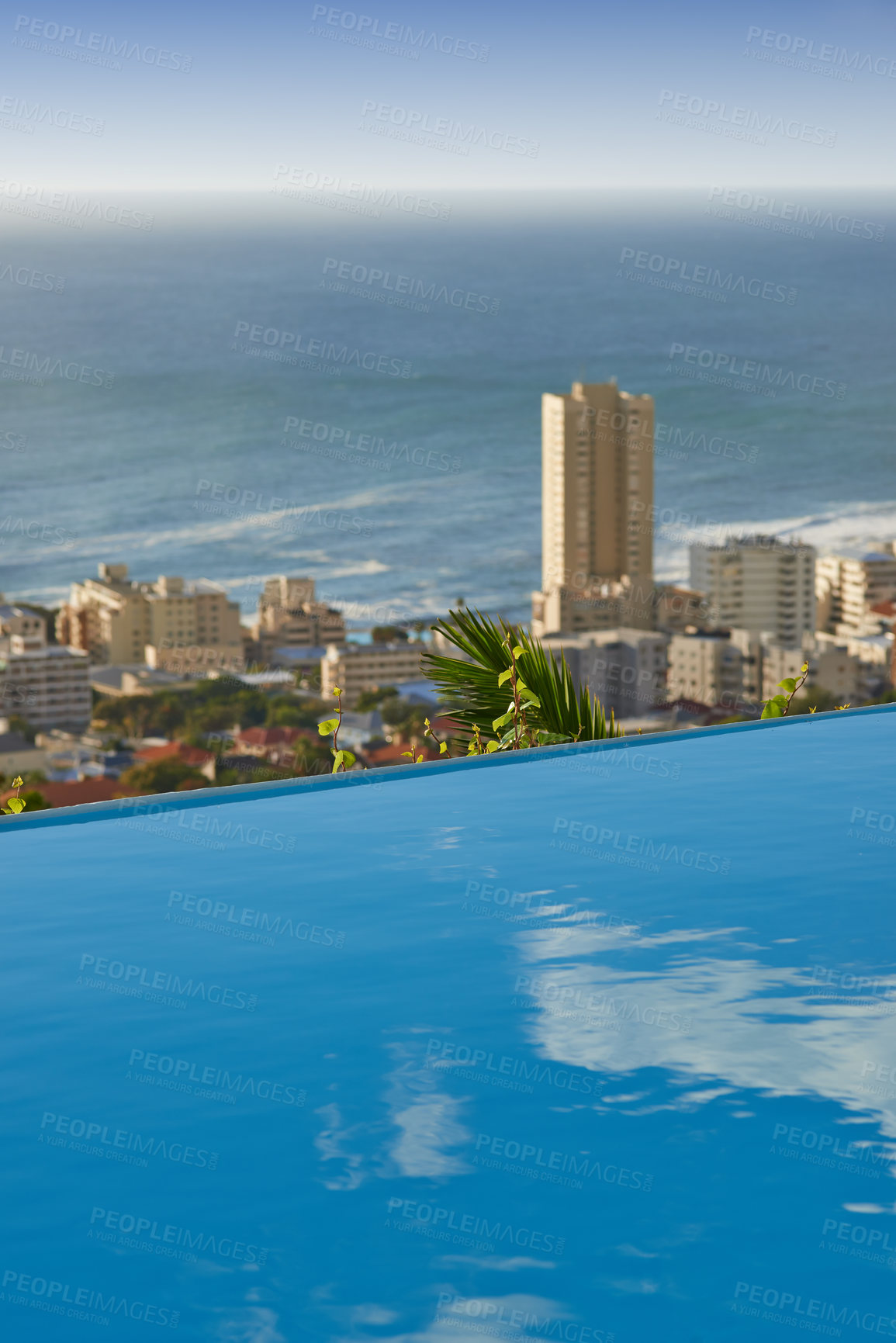 Buy stock photo Scenic view of infinity swimming pool overlooking Sea Point in Cape Town, South Africa with ocean background. Luxury outdoor desk, rooftop feature in a condo, home, hotel. Cityscape, skyline of city
