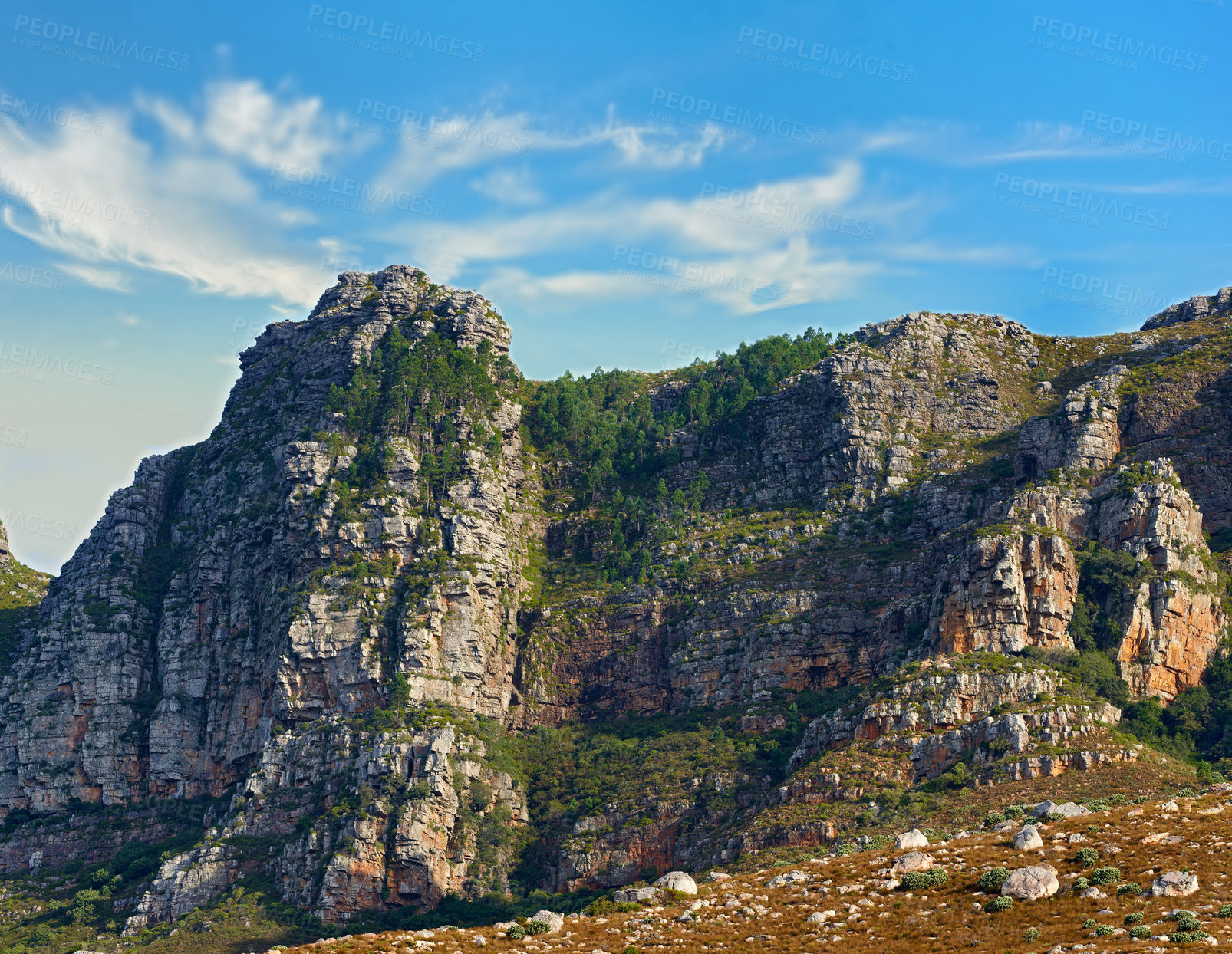 Buy stock photo Low angle view of a mountain peak in South Africa. Scenic landscape of a remote hiking location on Lions Head in Cape Town during a sunny day. Travelling and exploring nature through adventure