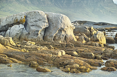 Buy stock photo Seascape, landscape, scenic view of boulders and rocks in Hout Bay, Cape Town, South Africa. Ocean, sea washing onto a rocky beach. Travel and tourism abroad, overseas for summer holiday and vacation