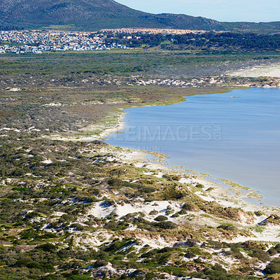 Buy stock photo Landscape of land meeting ocean in Hout Bay in Cape Town, South Africa. Beautiful tourist attraction of scenic fields and calm blue water. Exploring nature and wild. Top view of a scenic environment