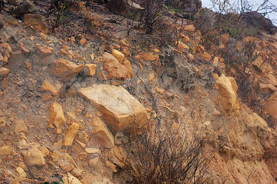 Buy stock photo Sedimentary rock layers formed on or near the Earth's surface. View of mountain soil texture with dry scrubs. Rocky landscape along remote hiking trail in nature. Geology wonders of South Africa