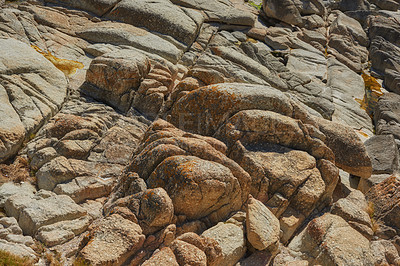 Buy stock photo Closeup of large rocks or boulders near the mountains.  Large multicolored granites. Details of big grey stone structures with orange particles shining in the sunlight. Sandstones with rough textures