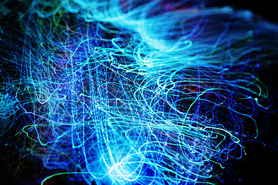 Buy stock photo Long exposure of fiber optical light cables in LED neon blue glow. Optics with spiral motion effects for fast data, network and internet usage. Digital abstract of electric lines on dark background