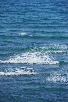 Buy stock photo Calm waves in the empty ocean on a sunny day. Beautiful sea water with light ripple effects on the surface. Abstract aqua textures in the deep wide sea. White foam patterns in the Atlantic or pacific